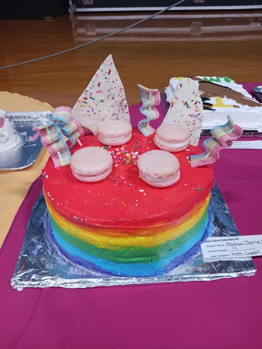 Maddie's rainbow cake with pink macarons and white chocolate shards — winner of Most Colorful Cake at the Great Cake Bake Off
